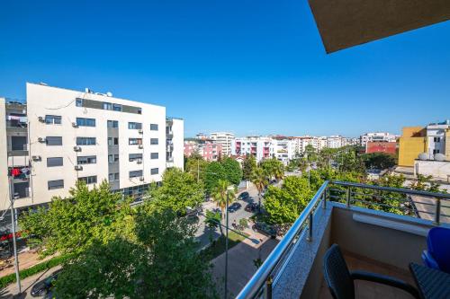 a balcony with a view of a city with buildings at Hotel Vila Misiri in Durrës
