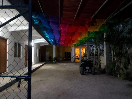 uma bandeira de arco-íris está pendurada no tecto de um edifício em Chentes Place em Barra de la Cruz