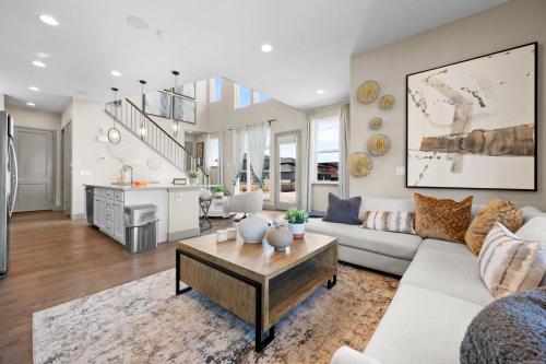 a living room with a couch and a table at Orleans Street - Aurora in Aurora