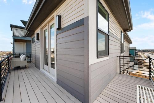 a house with a wooden deck with a door at Orleans Street - Aurora in Aurora