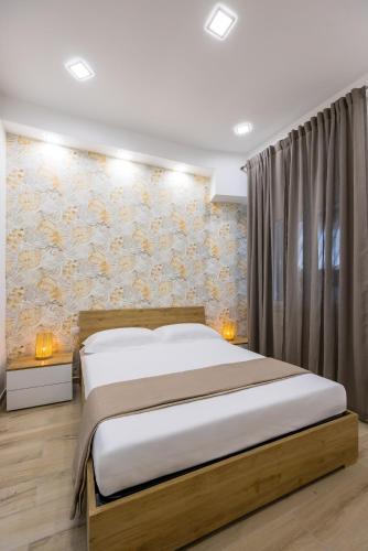 a bedroom with a bed and a floral wall at DCR House Murales in Naples