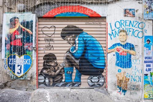 a garage door with a painting of a woman at DCR House Murales in Naples