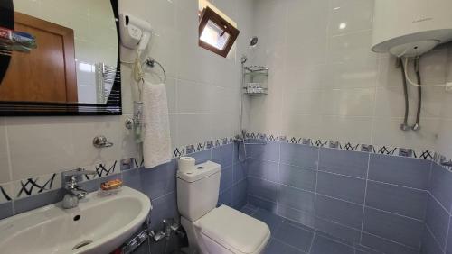 a bathroom with a toilet and a sink at Xəzər İstirahət Mərkəzi in Bunud