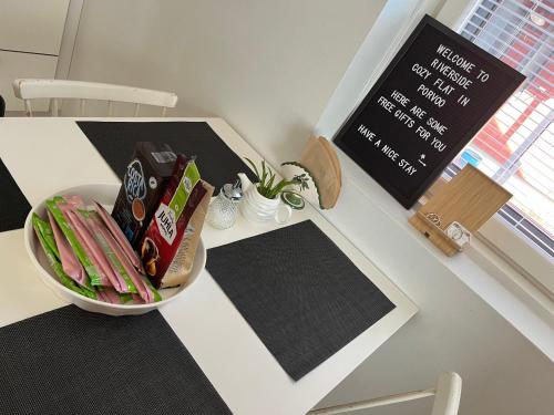 a table with a bowl of food and a sign at Riverside cozy flat in Porvoo in Porvoo