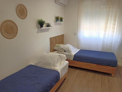 Ένα ή περισσότερα κρεβάτια σε δωμάτιο στο Mata Beach Caparica