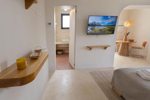 a white room with a bed and a bathroom at Al Poggiale - Residenza Mediterranea in Porto Cesareo