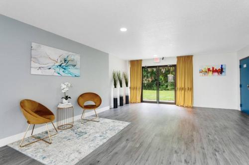 a living room with two chairs and a table at Oasis 203 - Symmetry & Serenity in Titusville
