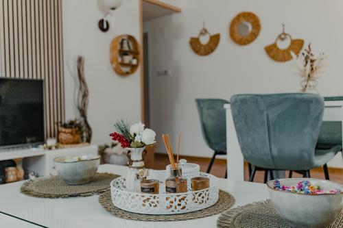 a table with bowls and jars on top of it at Vikendica Fruškogorski kutak - Fruška Gora in Čerević