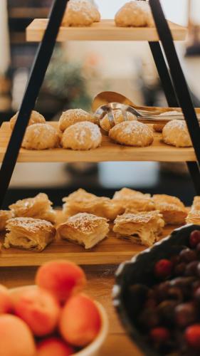 a bunch of different types of pastries on shelves at Brazzo di Maina in Oítilon