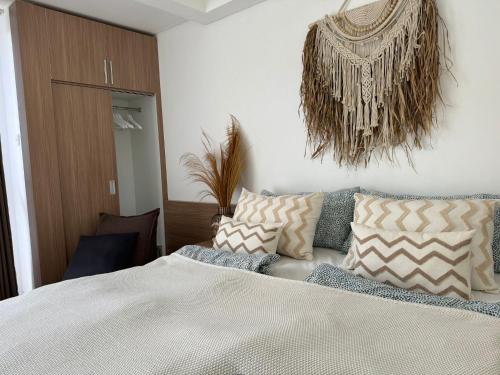a bedroom with a bed with pillows on it at Homely, Cozy Studio in Seminyak 5 in Seminyak