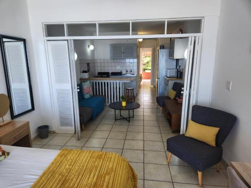 a room with a kitchen and a living room at Driftsands Sea View Flats in Uvongo Beach