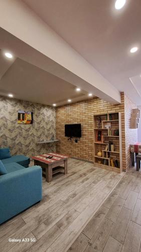 a living room with a blue couch and a table at Best apartments in downtown in Yerevan