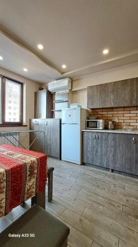 a kitchen with a white refrigerator and a table at Best apartments in downtown in Yerevan