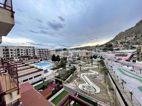 a view of a resort with a pool and buildings at Ático con terraza, piscina y jacuzzi in Villanueva de Río Segura