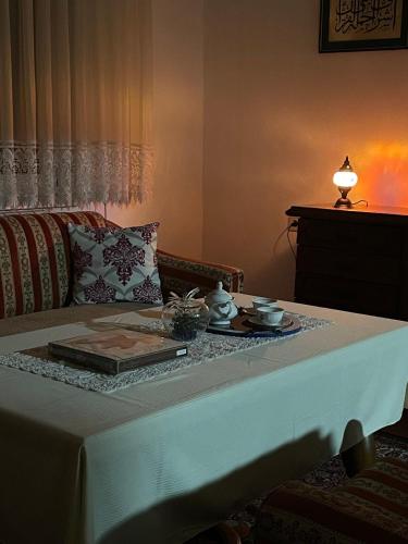 a living room with a table with a white table cloth at Apartment Old Town Visoko in Visoko