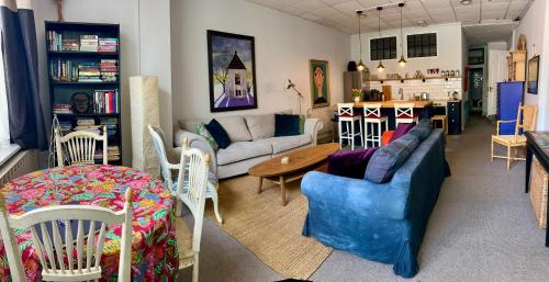 a living room with a couch and chairs and a table at Hampton Court Grand Snug Sleeps 6 - Walk to Palace and Train in Molesey