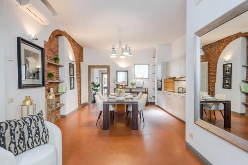 a living room with a white couch and a table at Georgia Modern Panoramic Penthouse with Elevator in Lucca