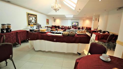 a banquet hall with a table with food on it at Hotel Guerrero in Mar del Plata