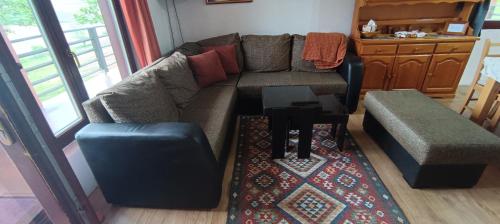 a living room with a couch and a table at Vikendica Jezerac in Banja Luka