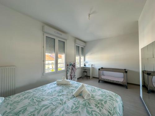 une chambre avec un lit, une table et des fenêtres dans l'établissement La Casa Metzervisse, à Thionville