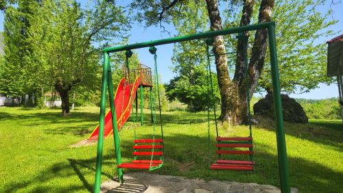 a playground with red swings in a park at Xəzər İstirahət Mərkəzi in Bunud