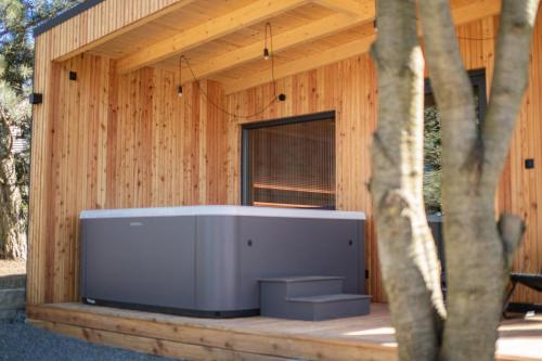 a large screen tv on a wooden building at Koliberek Apartament SPA in Szalejów Górny