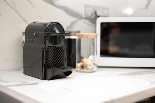 a coffee maker on a counter next to a microwave at MP Captain's House in Gythio