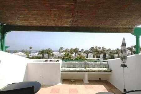 a living room with a large window with a couch at Coqueto apart en Las Coronas in Costa Teguise