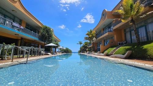 a swimming pool in front of some buildings at Thaproban Pavilion Waves in Unawatuna