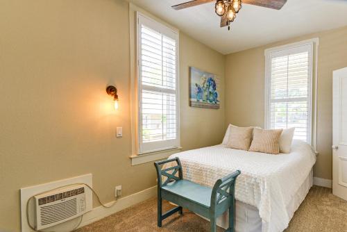 a bedroom with a bed and a chair and windows at Walk to Courthouse Square Quiet Home with Porch in Prescott