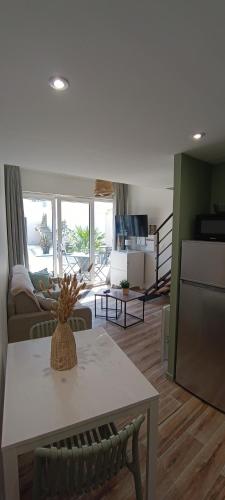 un salon avec une table et un canapé dans l'établissement Le Colibri, à Saint-Jean-de-Monts