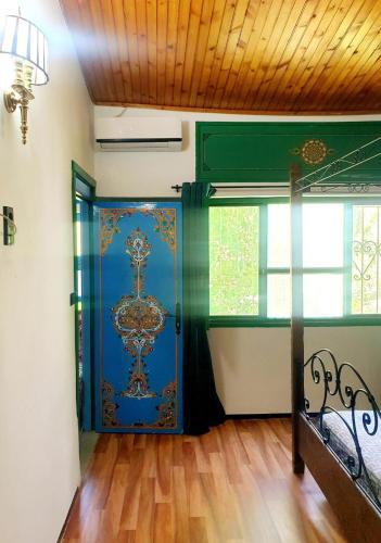 a room with a door with a painting on it at hotel Casa Love Dreams chefchaouen in Chefchaouene