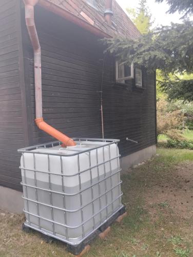 a large white bucket sitting outside of a house at Chata u řeky Orlice in Hradec Králové