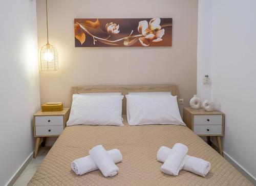 a bedroom with a bed with two white pillows at DUOMO City Center Suites, 1st Floor in Heraklio Town