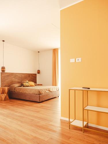 a bedroom with a bed and a table in it at U Zuccareddu in Alcamo