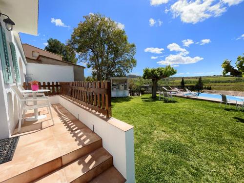 a patio with a wooden fence and a yard at Bed & Breakfast Wine & Cooking Penedès in Pla del Panadés