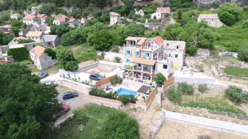an aerial view of a house with a swimming pool at Two houses Villa Diana Jesenice with pool, sauna, playground in Jesenice