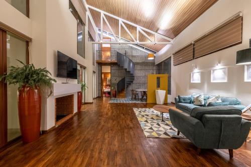 a living room with a couch and a fireplace at Asta in Ooty
