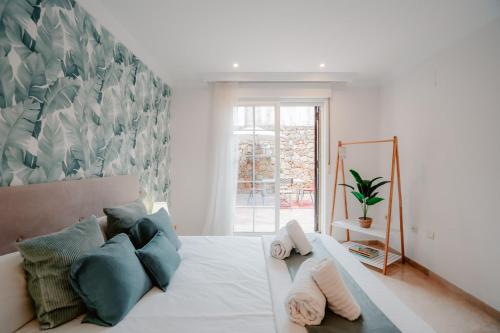 マルベーリャにあるBeach House ELVIRIAのベッドルーム(青い枕の大きな白いベッド付)