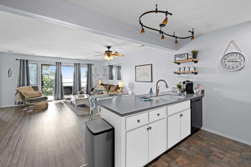 a kitchen and living room with white walls and a ceiling at Lakefront, Fireplace Home Near Silver Dollar City in Kimberling City