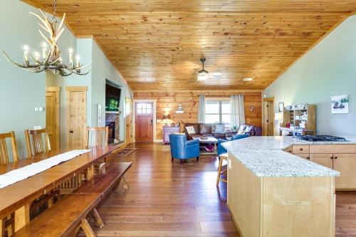 a kitchen and living room with wooden ceilings at Family Cabin with Private Hot Tub and Views in Boone! in Boone