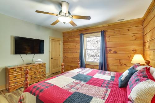 a bedroom with a bed and a flat screen tv at Family Cabin with Private Hot Tub and Views in Boone! in Boone