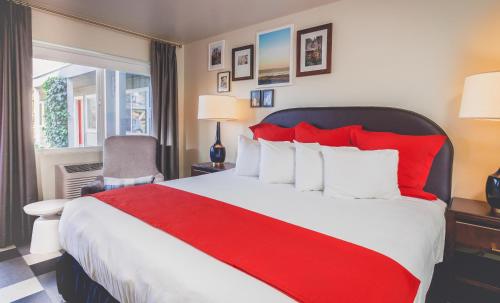 a hotel room with a large bed with red pillows at LiA Hotel in San Carlos