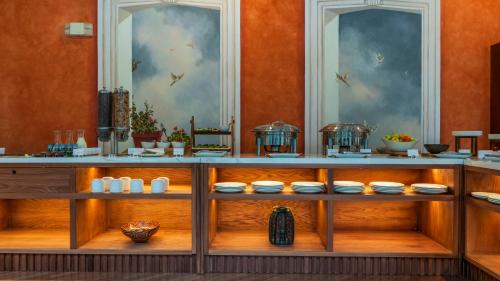 a display cabinet with bowls and dishes on it at Hotel Patio Andaluz in Quito