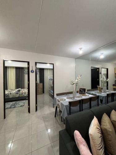 a living room with a couch and a table at Casa Moanna 2BR Condo with Dining, kitchen, Living Area and Netflix in Mandaue City