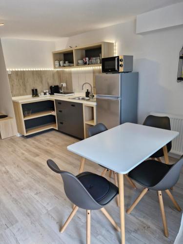 a kitchen with a table and chairs in a room at Apartma Vovk in Mojstrana