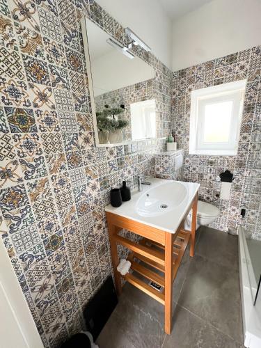 a bathroom with a sink and a mirror at Ronia apartment in Kaštela