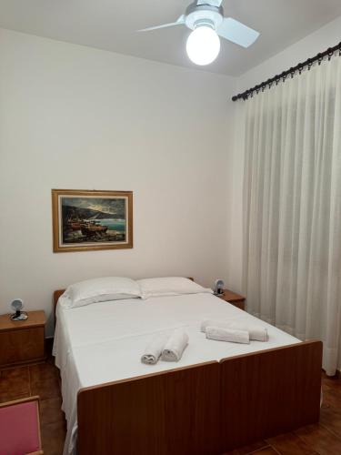 a bedroom with a bed with two white towels on it at Residence La Scogliera in Alassio