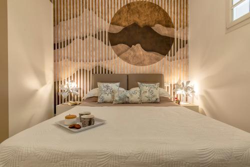 a bedroom with a bed with a tray of food on it at Luxury Sofia Home Alghero in Alghero