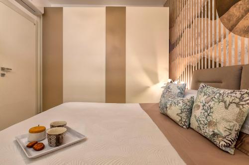 a bed with a plate of donuts on it at Luxury Sofia Home Alghero in Alghero